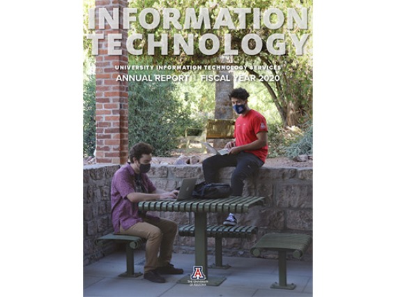cover of the annual report - 2 students working on laptops at Old Main